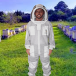 3 Layers Ultra Breeze Ventilated Beekeeping Bee Suit with Fencing Veil worn by a beekeeper during hive inspection. Lightweight triple-layer mesh fabric provides sting-resistant protection, maximum airflow, and all-day comfort. Features a detachable fencing veil, durable zippers, elastic cuffs, and full-body coverage for professional and hobbyist beekeepers.