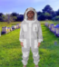 3 Layers Ultra Breeze Ventilated Beekeeping Bee Suit with Fencing Veil worn by a beekeeper during hive inspection. Lightweight triple-layer mesh fabric provides sting-resistant protection, maximum airflow, and all-day comfort. Features a detachable fencing veil, durable zippers, elastic cuffs, and full-body coverage for professional and hobbyist beekeepers.